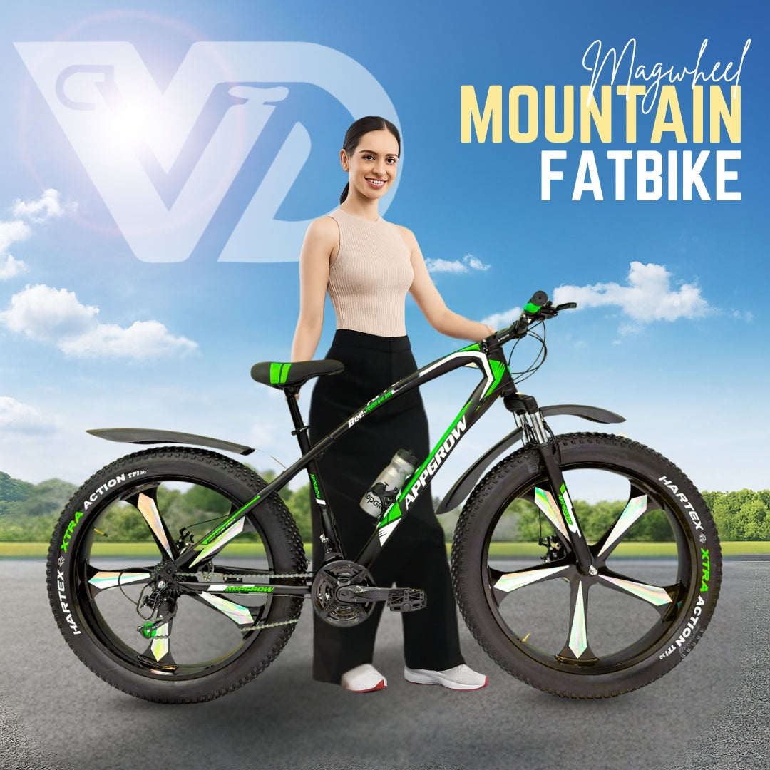 26T Appgrow Fat Jaguar green and black mountain fatbike with mag wheels, model standing beside the bike in an outdoor setting under blue sky.