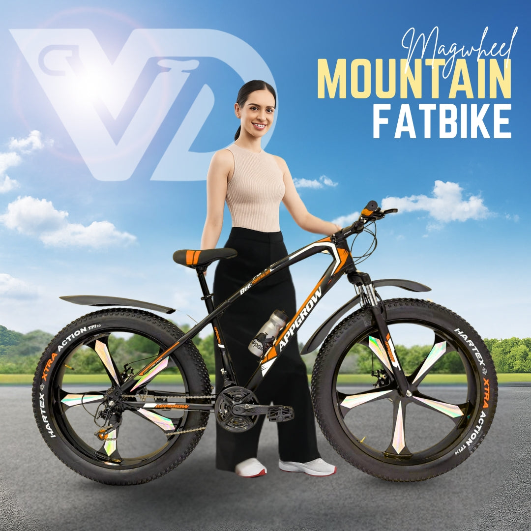 26T Appgrow Fat Jaguar orange and black mountain fatbike with mag wheels, showcased outdoors with a smiling model and clear sky.