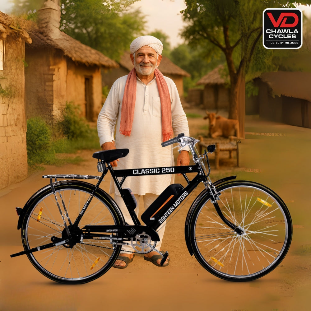 Classic 250 black electric cycle by Eighteen Motors, shown with a rural man in traditional attire, village background, and VD Chawla Cycles branding.
