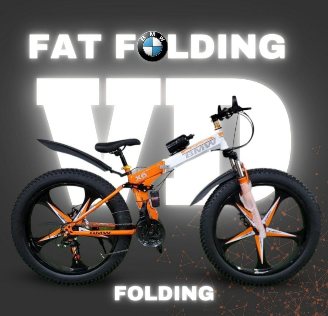 "Orange and white BMW 26T folding cycle with fat tyres, X6 suspension frame, and disc brakes, displayed on a VD branded backdrop with FAT FOLDING text"

