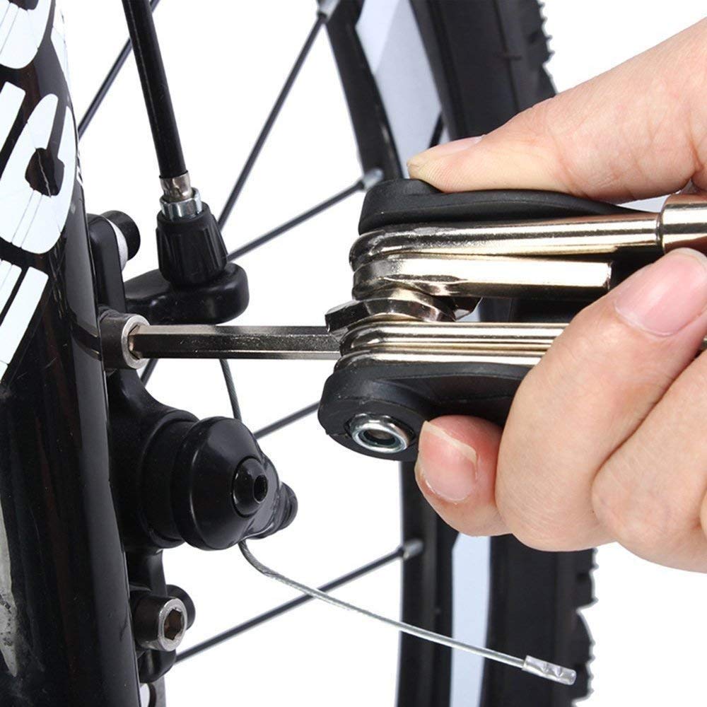 Allen key tool kit being used to adjust bicycle brake caliper