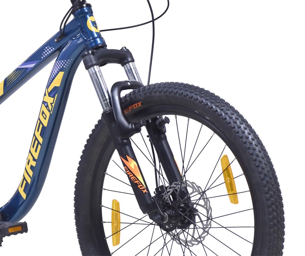 Front view of Firefox Dominator 24D showing the suspension fork, front disc brake, knobby tire, and Firefox branding on the fork.
