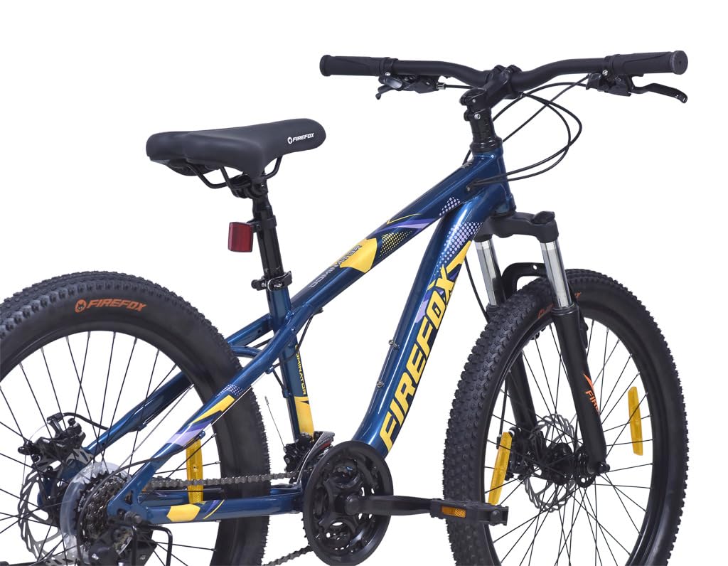 Rear angled view of Firefox Dominator 24D mountain cycle featuring 21-speed gear system, suspension fork, disc brakes, and sporty frame graphics.
