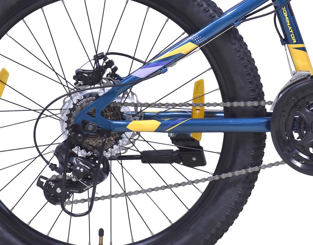 Close-up of the Firefox Dominator 24D's rear wheel showing the multi-speed cassette, disc brake, and derailleur system with yellow reflector and chainstay graphics.
