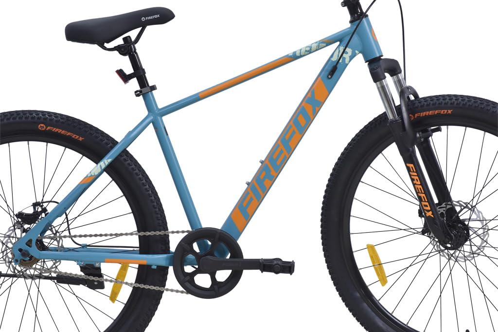 Side profile of Firefox Dominator mountain cycle in blue with orange decals, showing frame, tires, disc brakes, and saddle on white background

