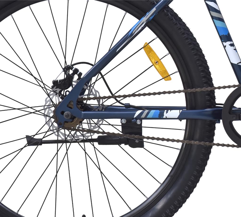 Rear close-up view of the FIREFOX Tremor X 29 D blue MTB showing the chain, disc brake rotor, frame dropout, and wheel with reflector against a white background.

