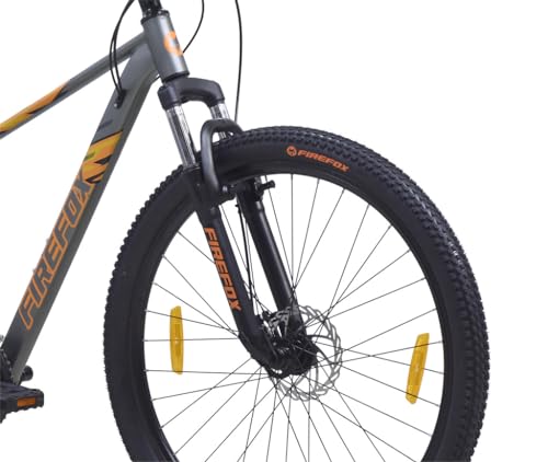 Close-up view of the front suspension fork and tyre of the FIREFOX Tremor X 29 D mountain cycle, featuring 29-inch wheels and disc brake.
