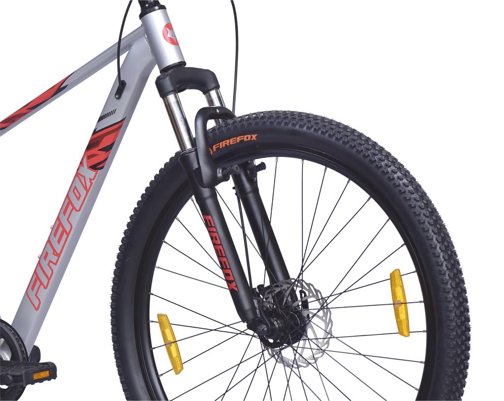 Close-up of front suspension fork and tyre with disc brake of the FIREFOX Tremor X 29 D single speed mountain bicycle in silver.
