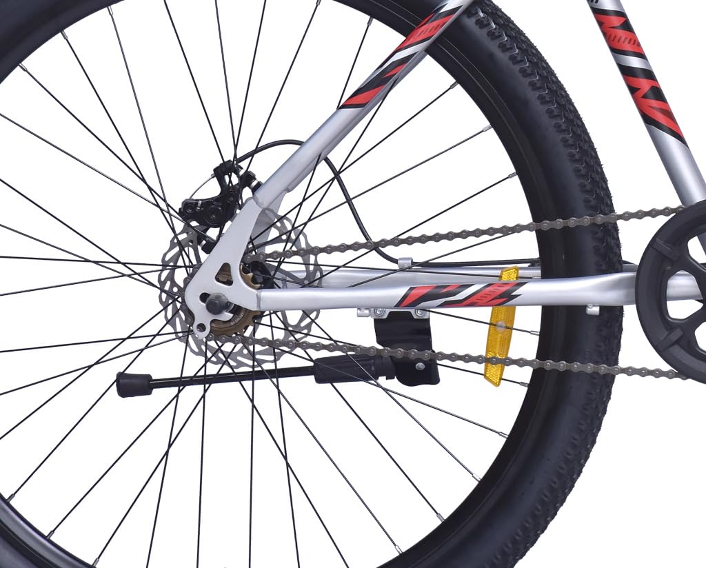 Close-up of rear wheel, disc brake, chain, and frame of the FIREFOX Tremor X 29 D single speed mountain cycle in silver.
