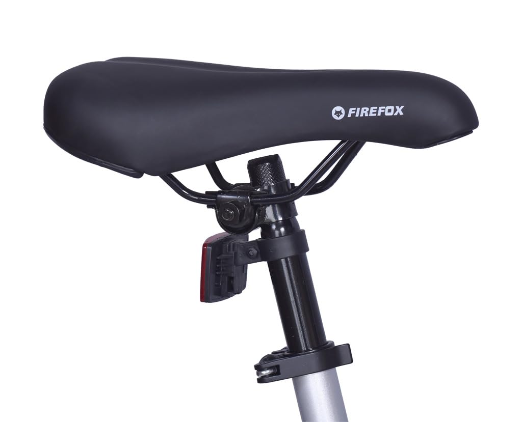 Close-up view of the comfortable saddle and seatpost of the FIREFOX Tremor X 29 D single speed mountain cycle in silver.
