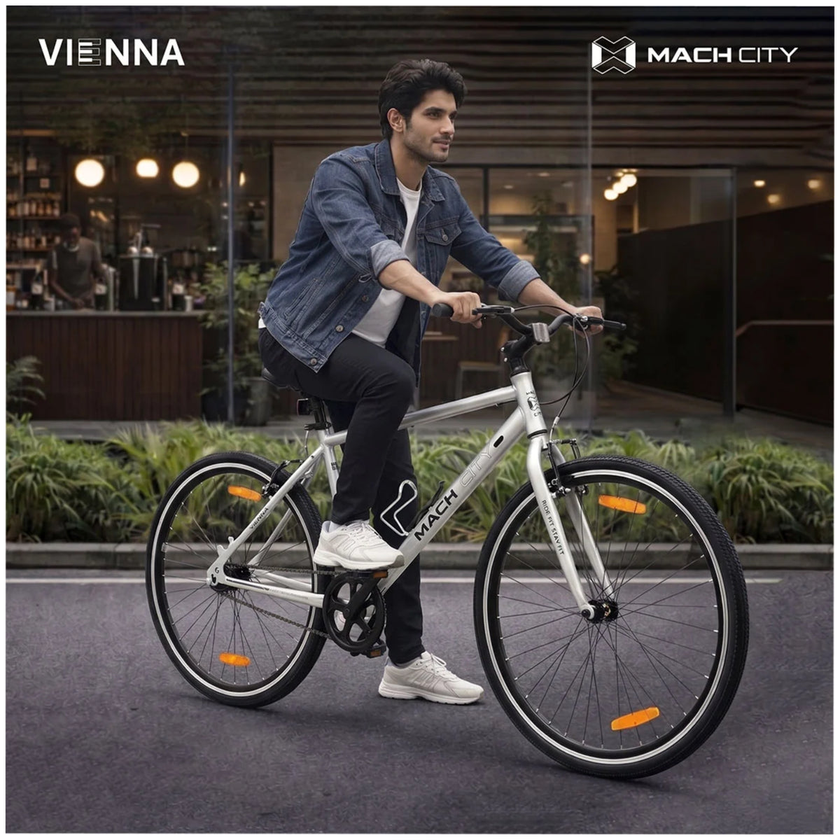 Mach City Vienna 700C Sparkle Silver city cycle with male rider