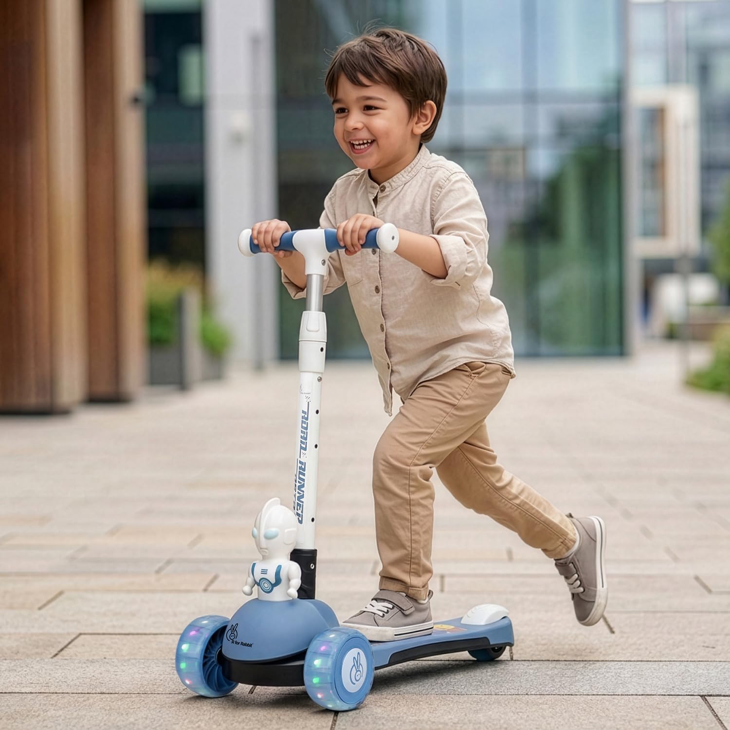 Kid riding R for Rabbit Road Runner Astro scooter outdoors