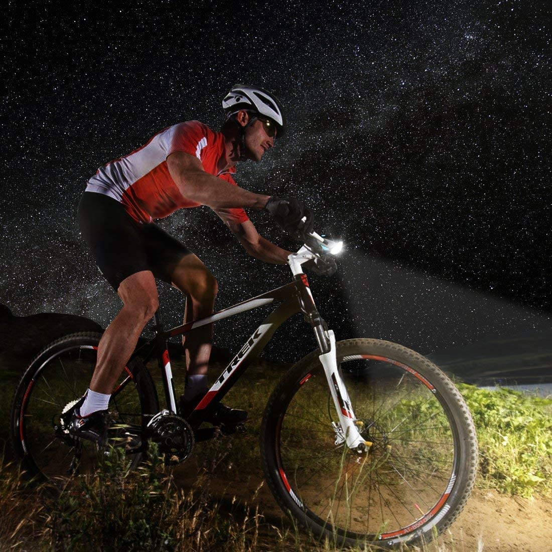 "Rechargeable cycle light with horn in use during night city ride"


