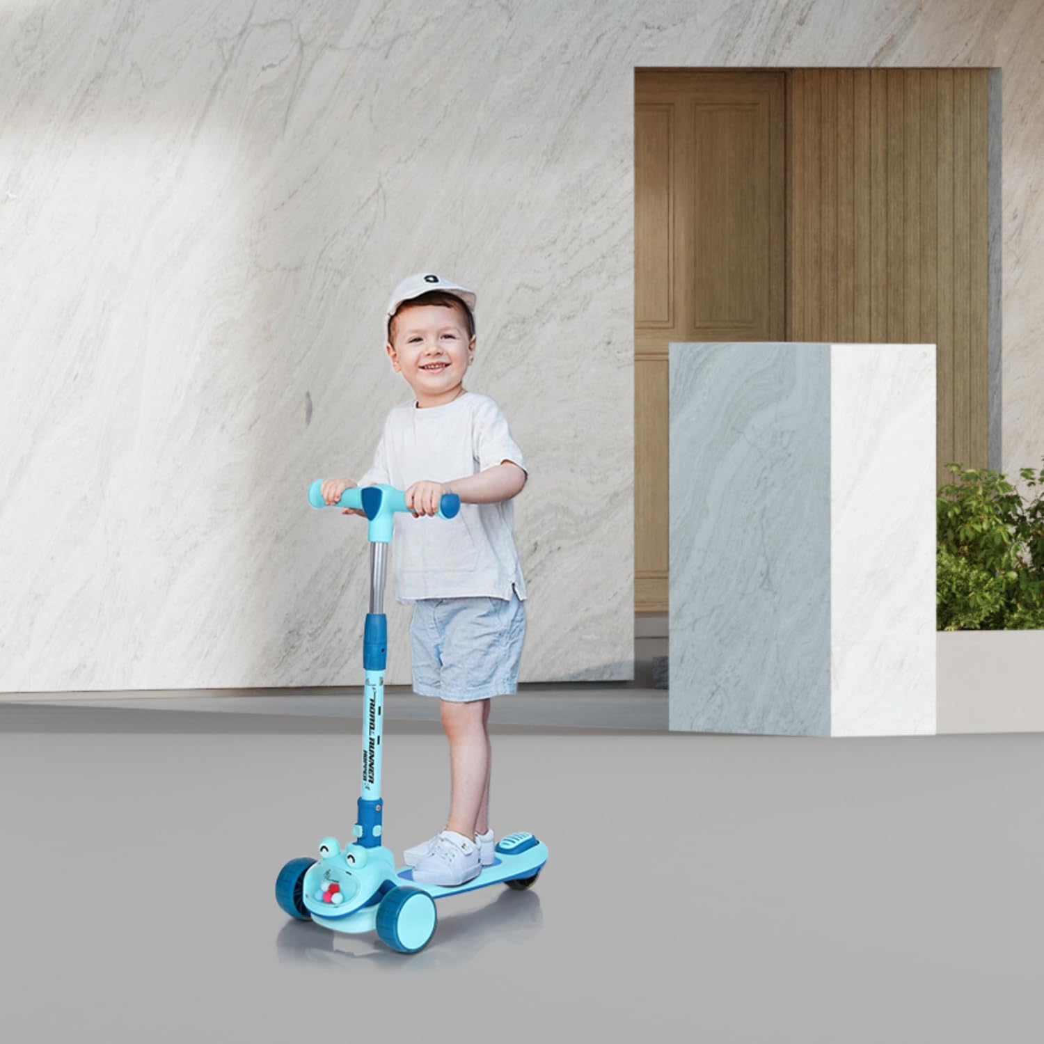 Kid riding R for Rabbit Road Runner Hopper scooter indoors