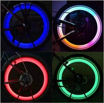 Valve Light Four bicycle wheels with glowing rims in blue, green, red, and multicolor on a black background.