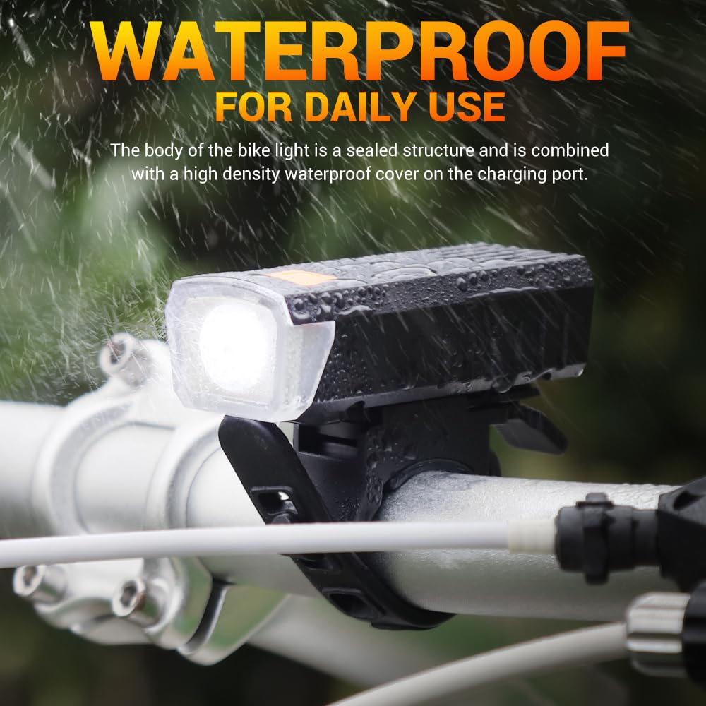 Waterproof rechargeable bicycle front light mounted on handlebar with water splash demonstrating rainproof performance.
